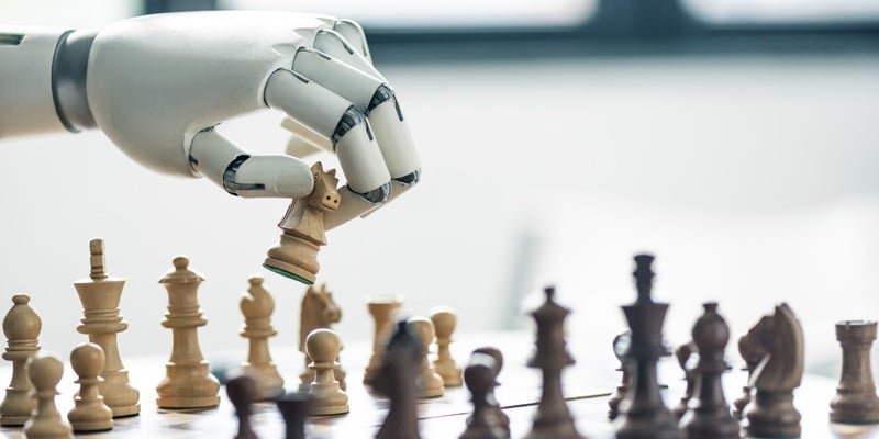Close up photo of a robot playing chess with a human